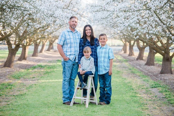 The Taylor family from Sutter County poses in a blooming orchard.
